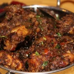 Dry Pepper Chicken coated with bold spices and black pepper, served with sautéed onions and herbs.